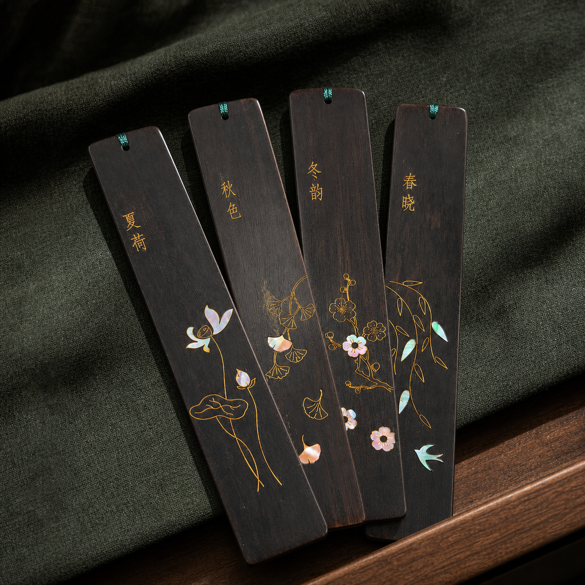 Four Seasons shell-inlay bookmark set on deep green fabric