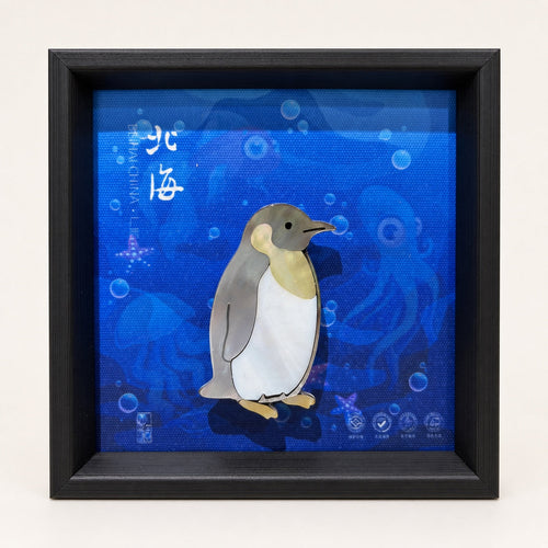 Penguin shell-inlay picture in a black frame